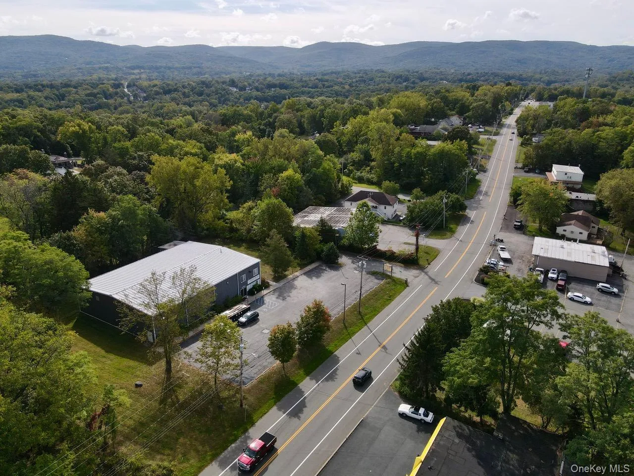 Drone / aerial view of a mountainous background and a forest Drone / aerial view of a mountainous background and a forest