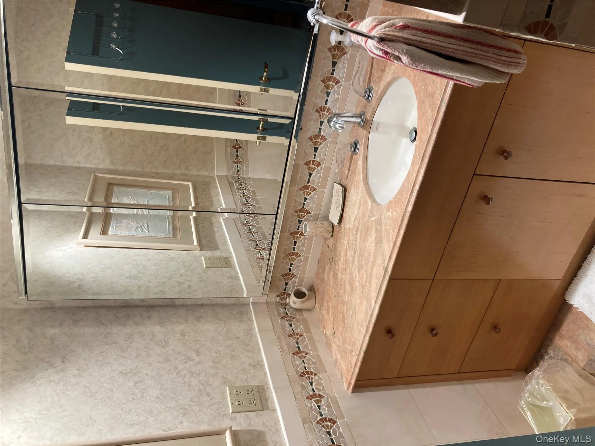 Bathroom featuring vanity and tile walls Bathroom featuring vanity and tile walls