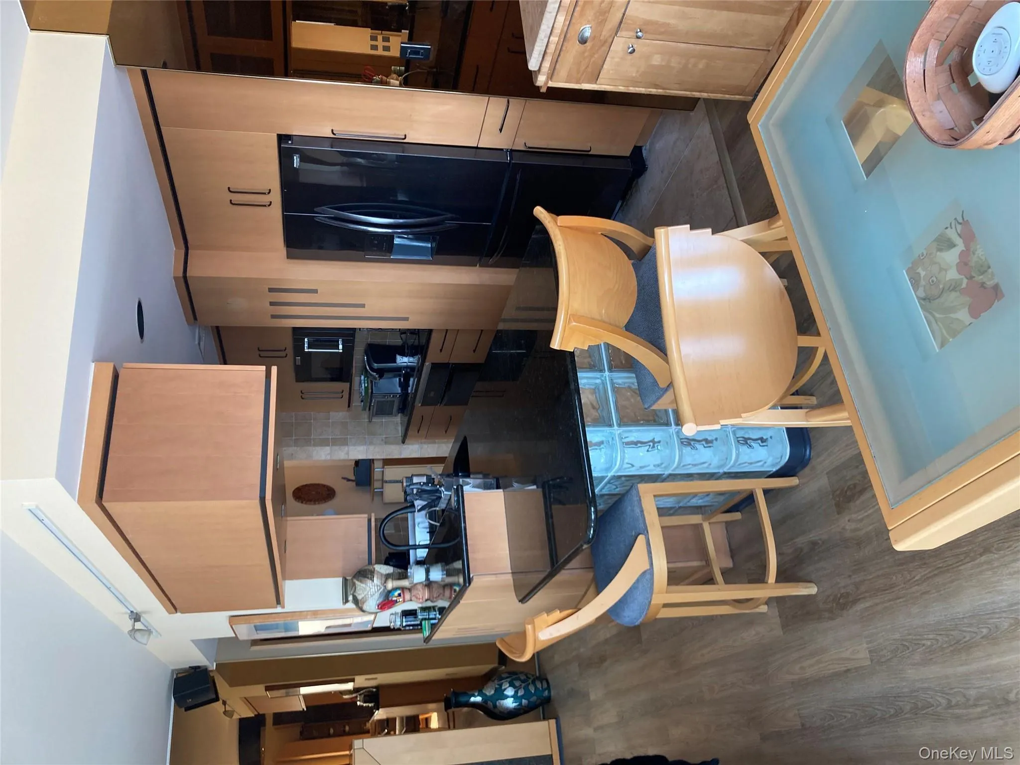 Kitchen featuring refrigerator, tasteful backsplash, dark wood-style flooring, light brown cabinets, and oven Kitchen featuring refrigerator, tasteful backsplash, dark wood-style flooring, light brown cabinets, and oven