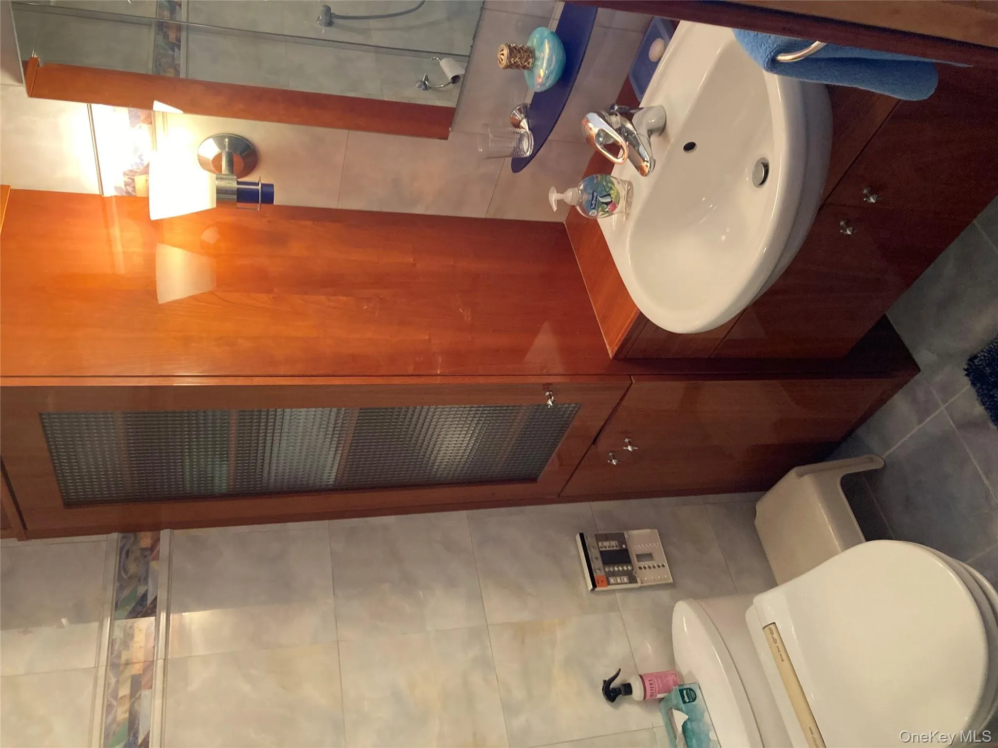 Bathroom with tile walls, tile patterned flooring, and vanity Bathroom with tile walls, tile patterned flooring, and vanity