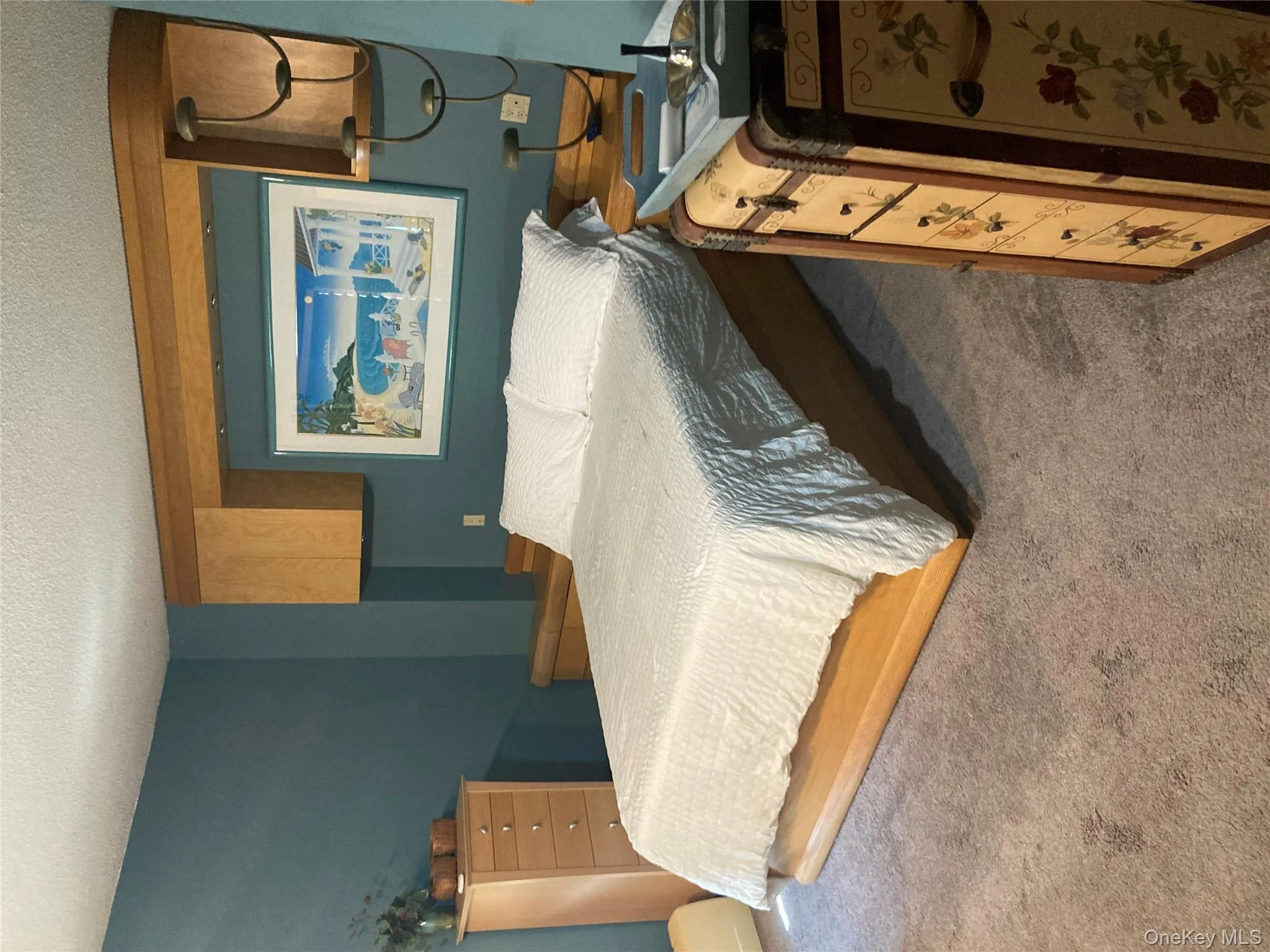 Bedroom featuring a textured ceiling and carpet floors Bedroom featuring a textured ceiling and carpet floors