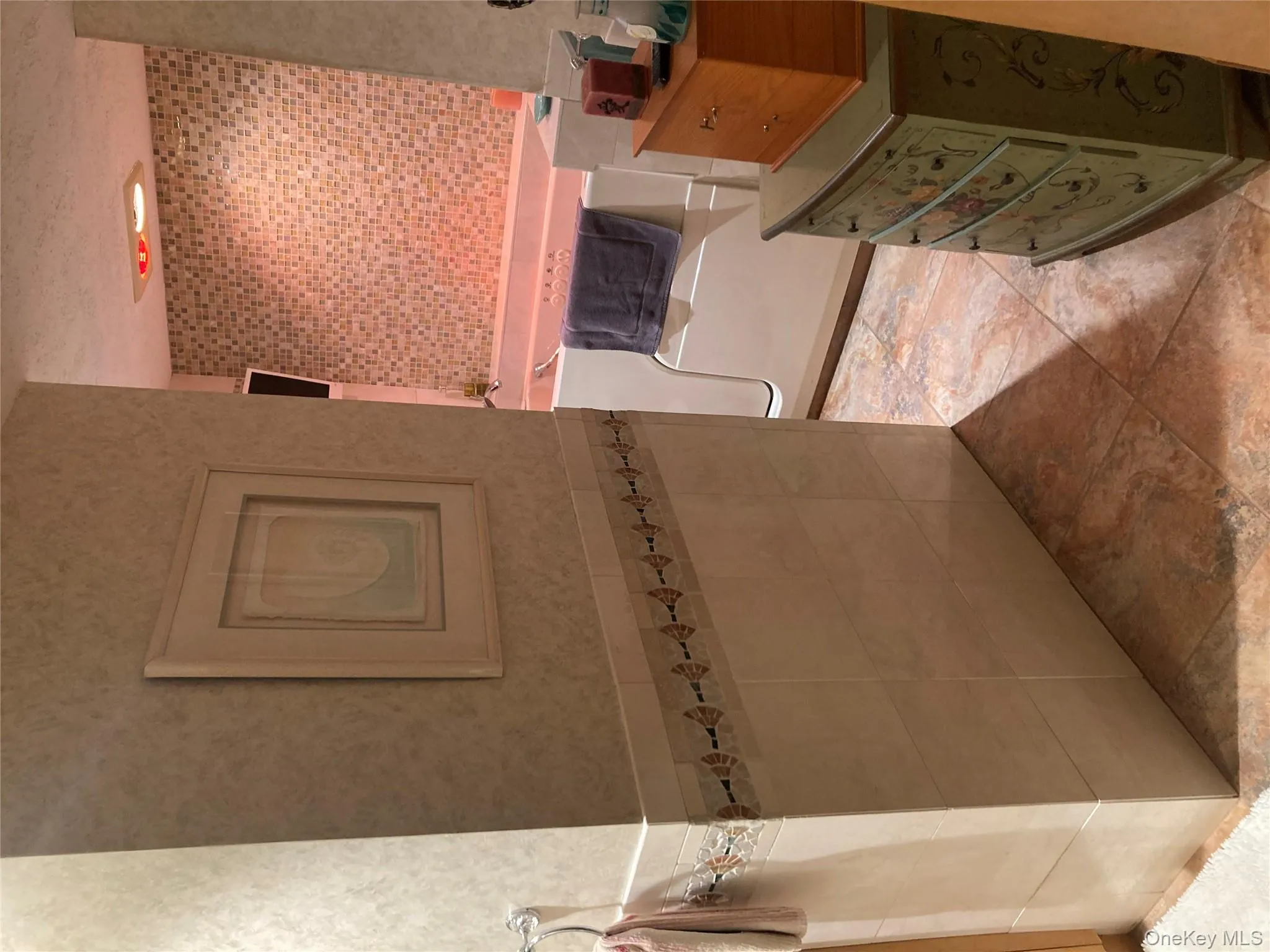 Full bathroom with tile walls, a bath, wainscoting, wallpapered walls, and tile patterned floors Full bathroom with tile walls, a bath, wainscoting, wallpapered walls, and tile patterned floors