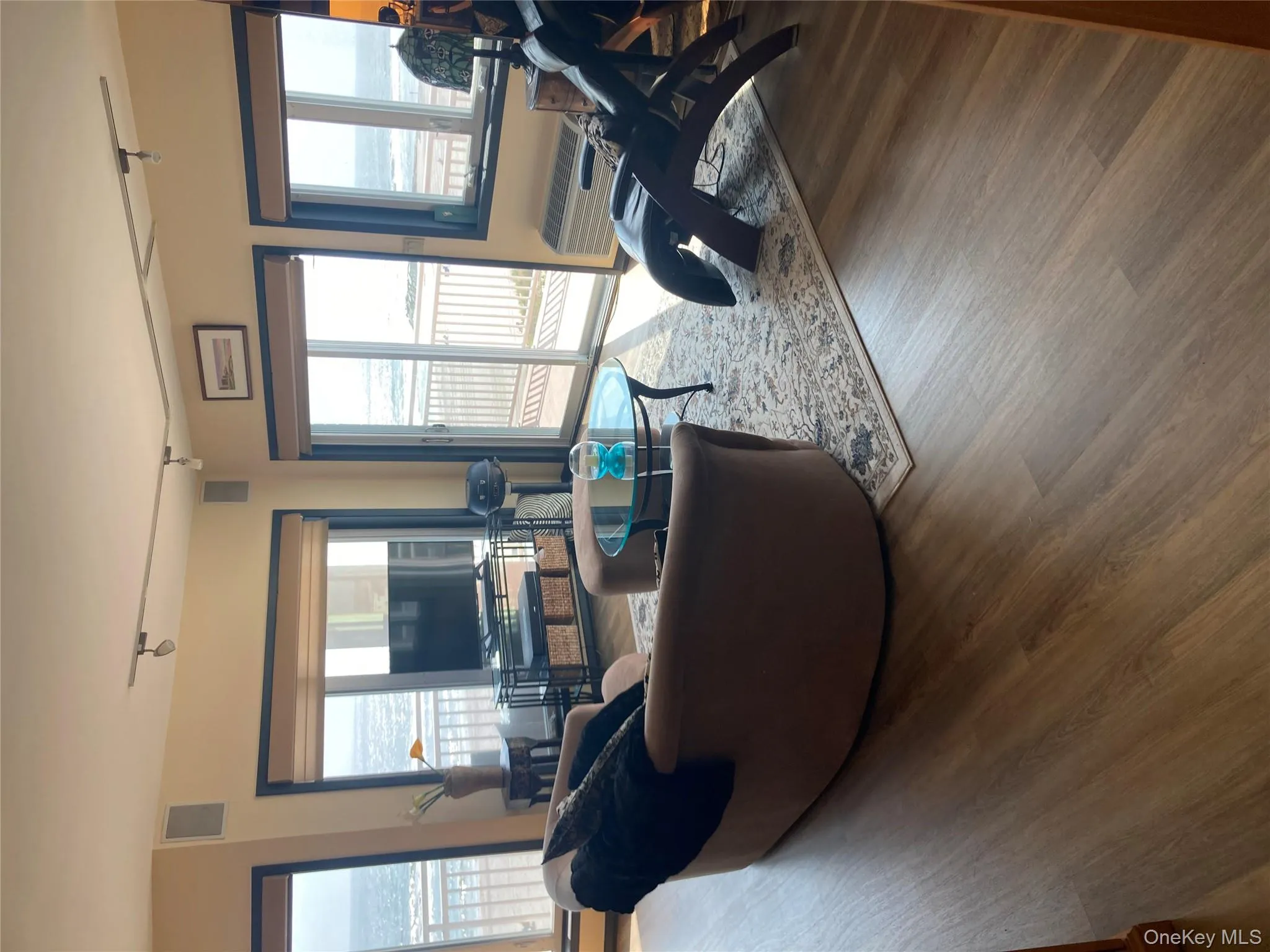 Living area featuring track lighting and wood finished floors Living area featuring track lighting and wood finished floors