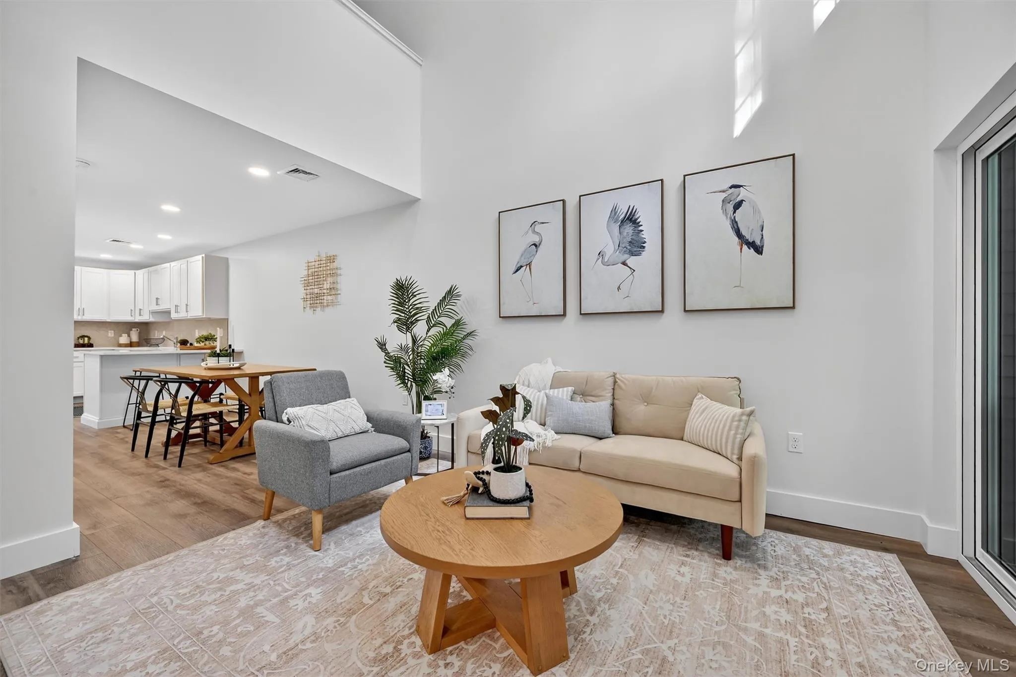 Living room with light wood finished floors and recessed lighting Living room with light wood finished floors and recessed lighting