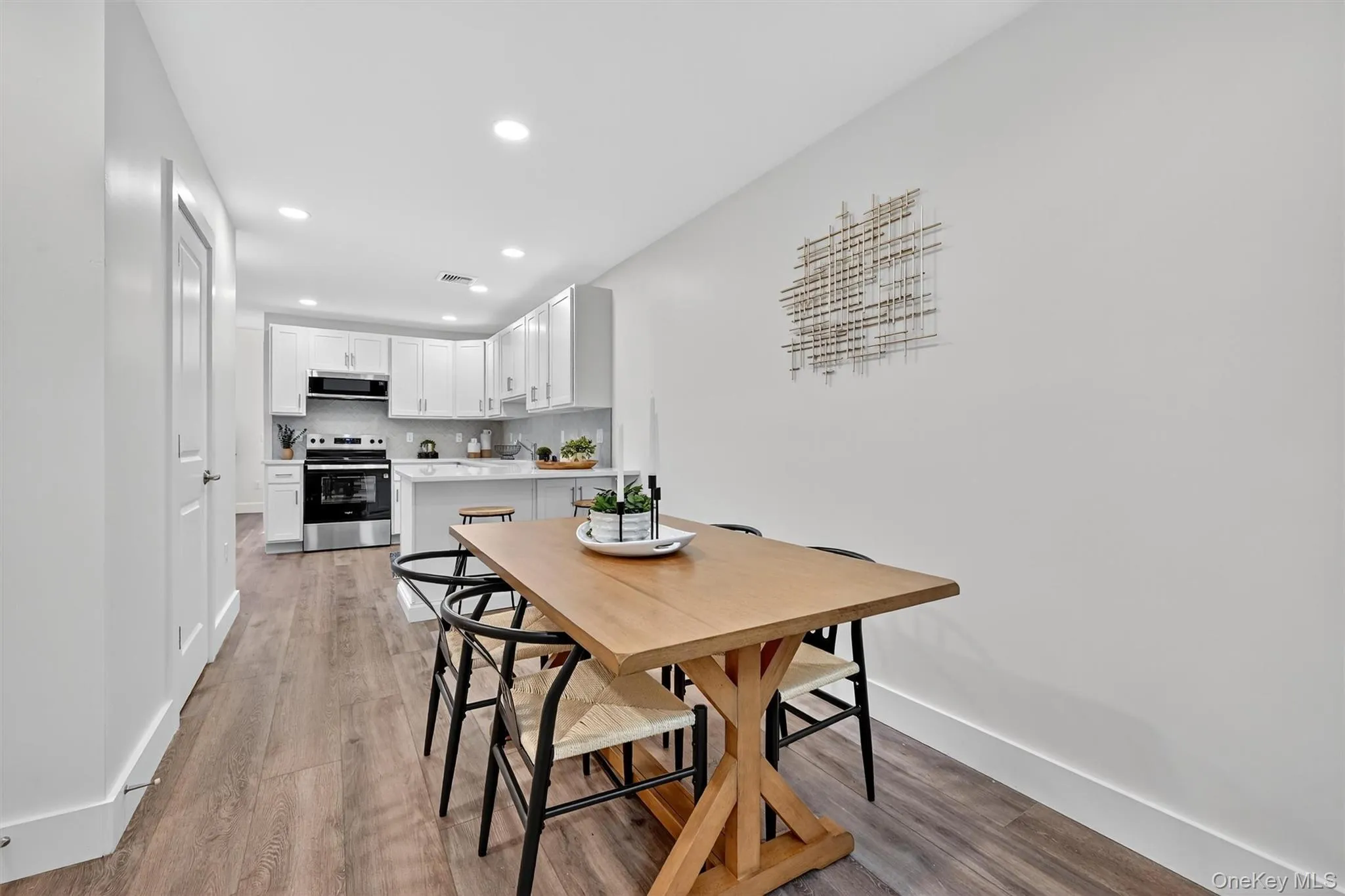 Dining area featuring light wood finished floors and recessed lighting Dining area featuring light wood finished floors and recessed lighting