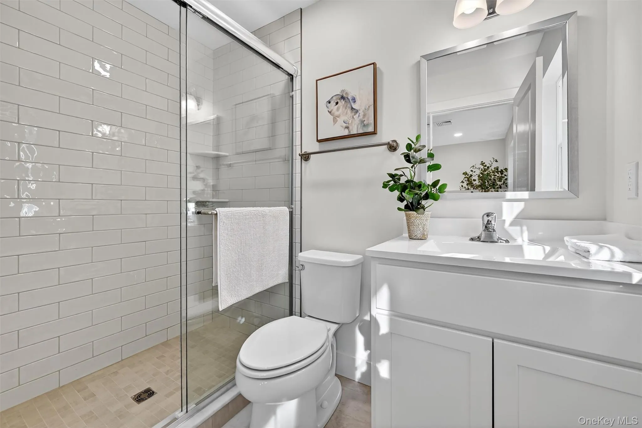 Bathroom featuring a stall shower and vanity Bathroom featuring a stall shower and vanity