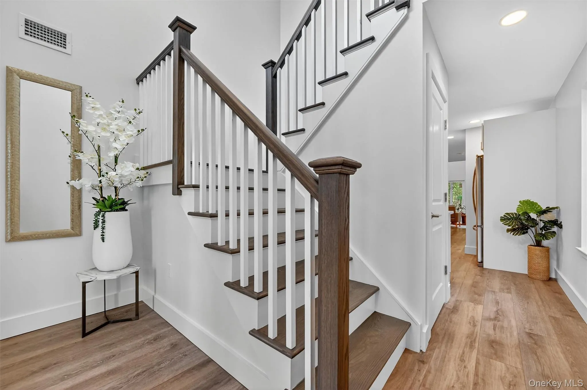 Stairway featuring wood finished floors and recessed lighting Stairway featuring wood finished floors and recessed lighting