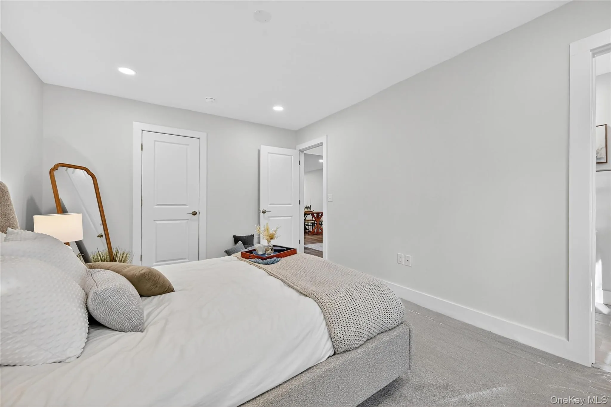 Bedroom featuring recessed lighting, ensuite bathroom, and carpet flooring Bedroom featuring recessed lighting, ensuite bathroom, and carpet flooring