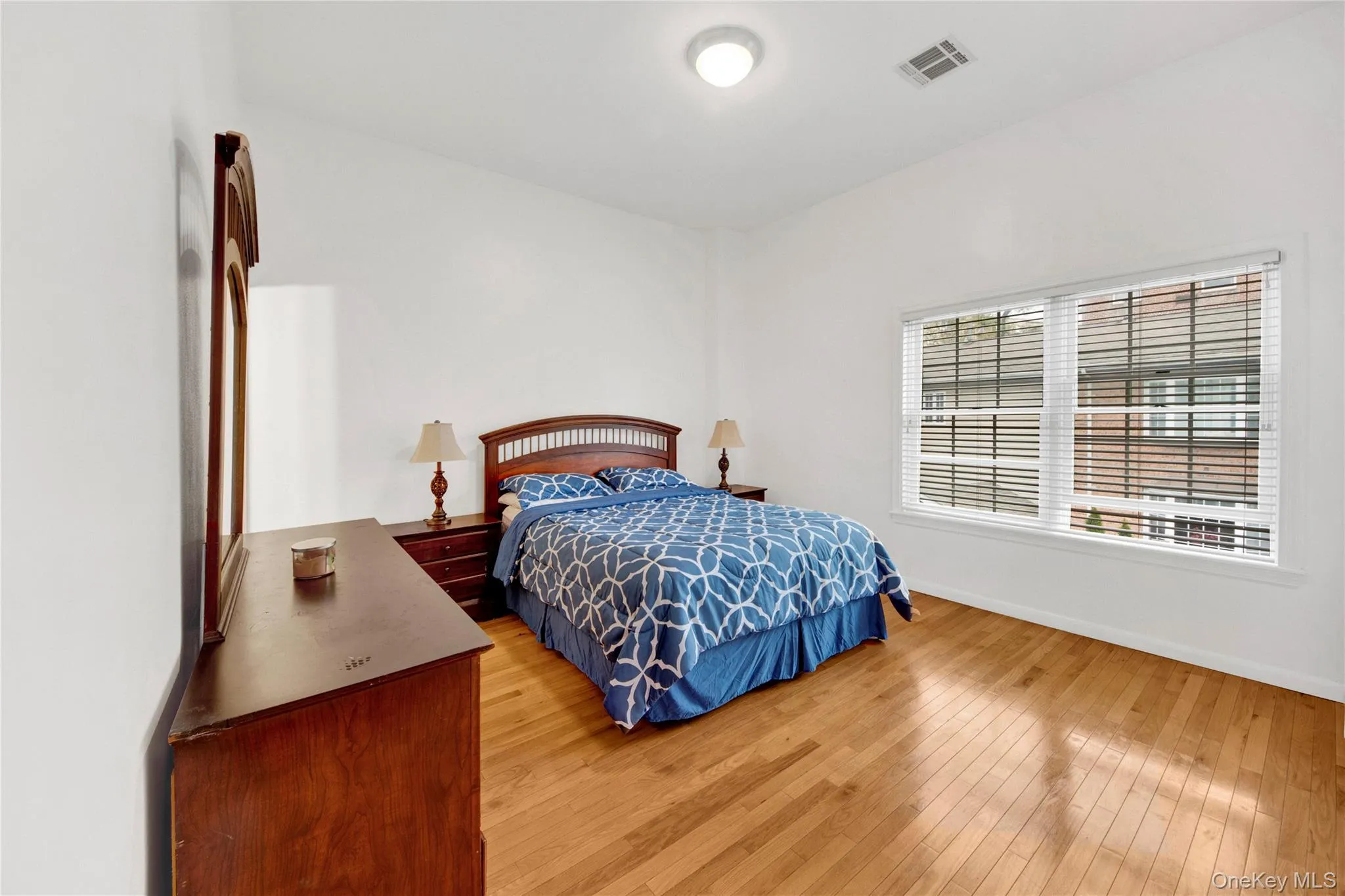 Bedroom featuring light wood-style flooring and baseboards Bedroom featuring light wood-style flooring and baseboards