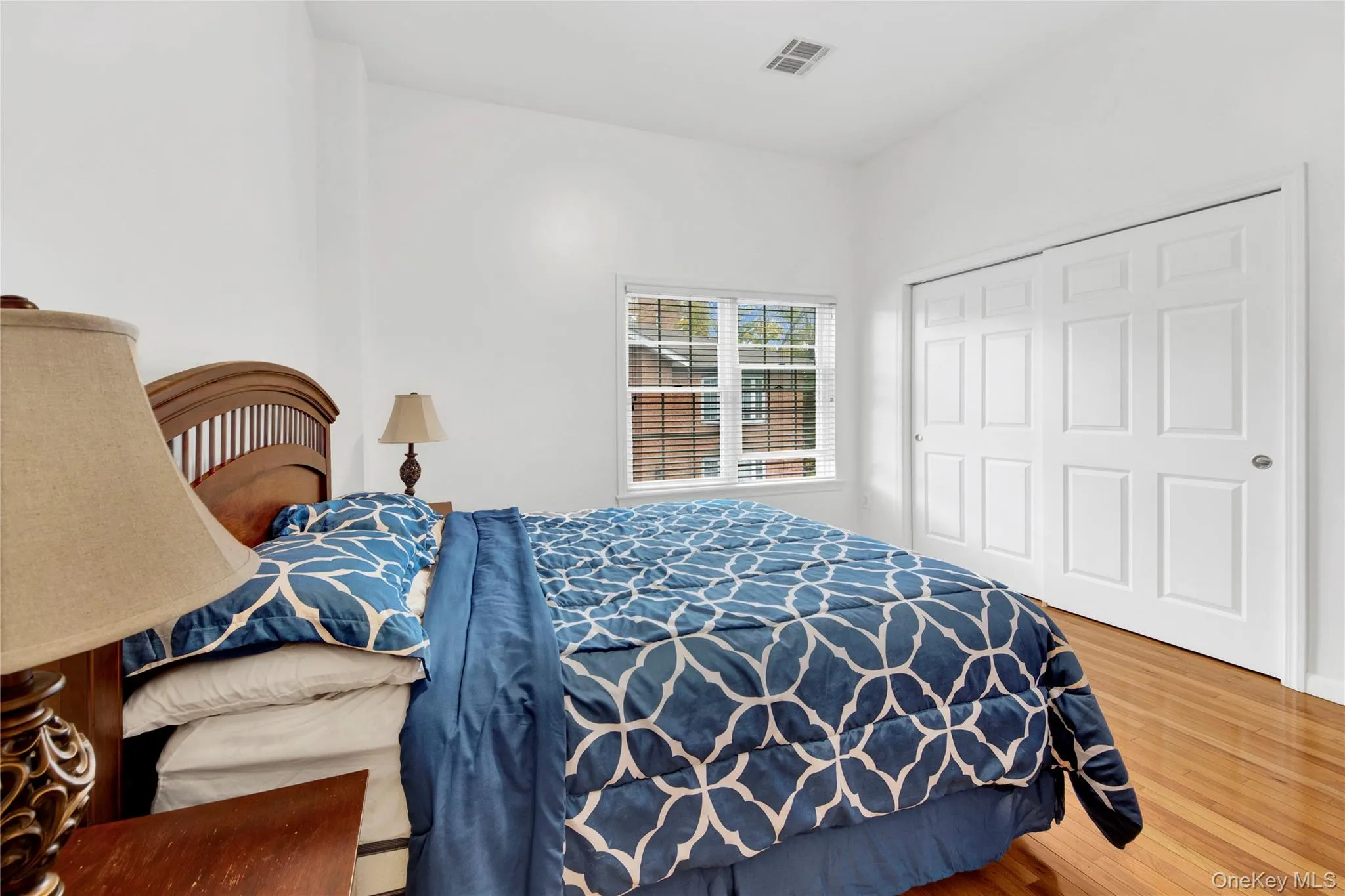 Bedroom featuring wood finished floors and a closet Bedroom featuring wood finished floors and a closet