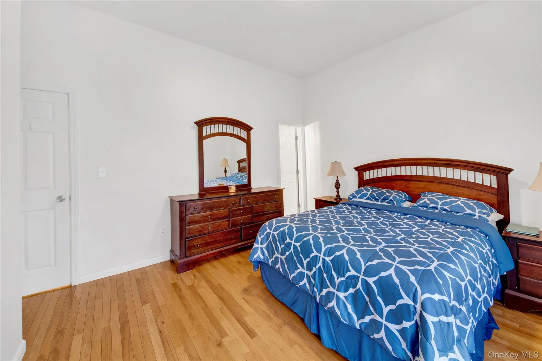 Bedroom featuring light wood-type flooring and baseboards Bedroom featuring light wood-type flooring and baseboards