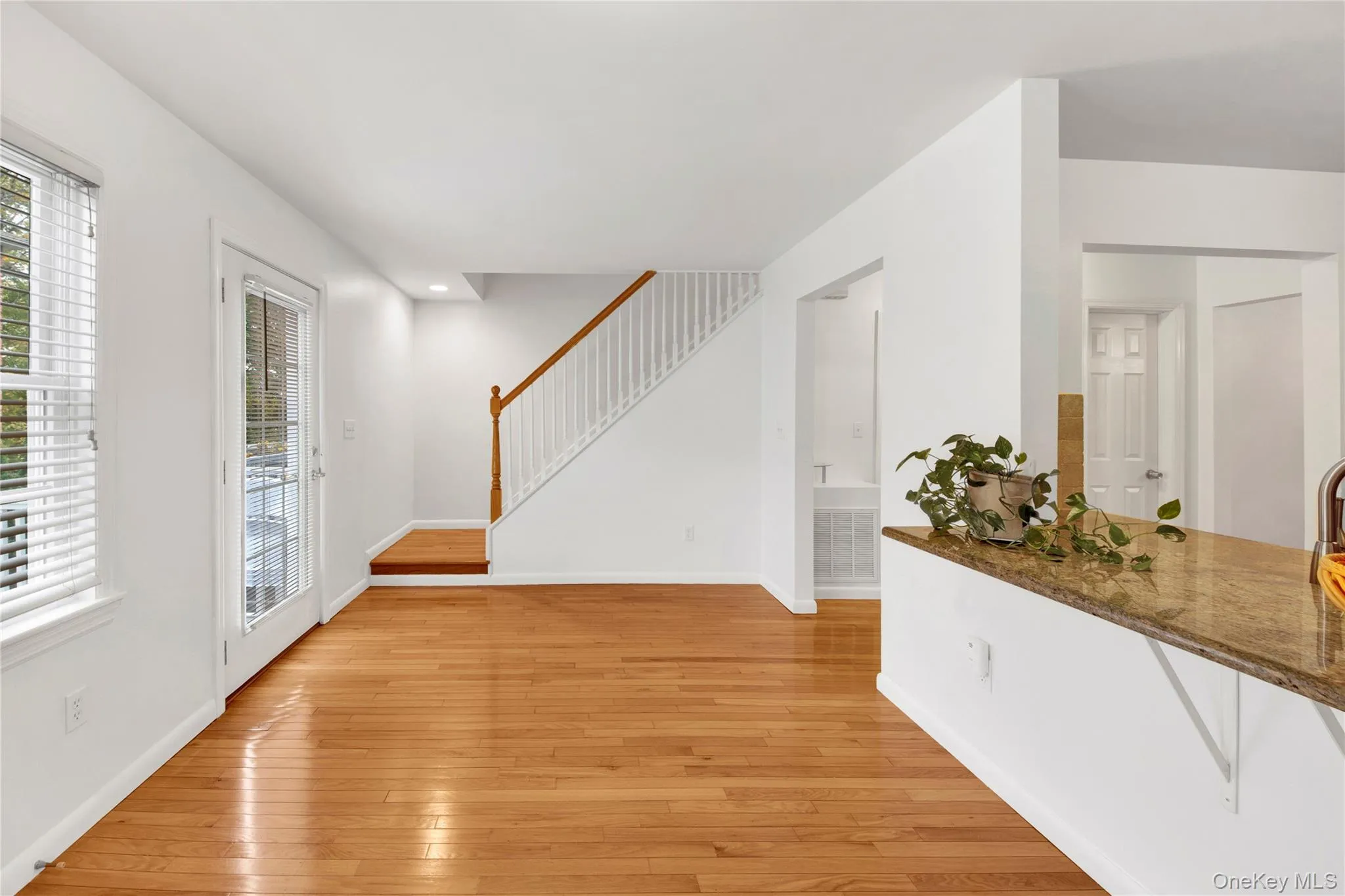 Foyer entrance with light wood-style flooring and stairs Foyer entrance with light wood-style flooring and stairs