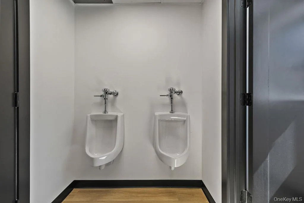 Bathroom view of baseboards and wood finished floors Bathroom view of baseboards and wood finished floors