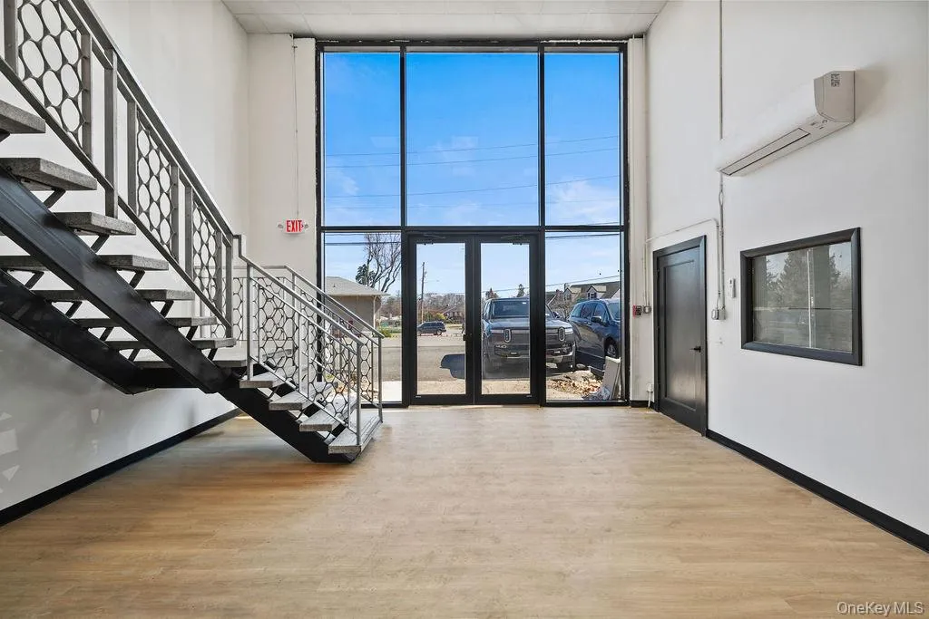 Community lobby with floor to ceiling windows, stairway, and a towering ceiling Community lobby with floor to ceiling windows, stairway, and a towering ceiling