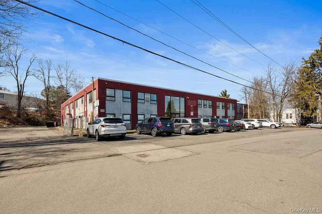 View of property featuring uncovered parking View of property featuring uncovered parking