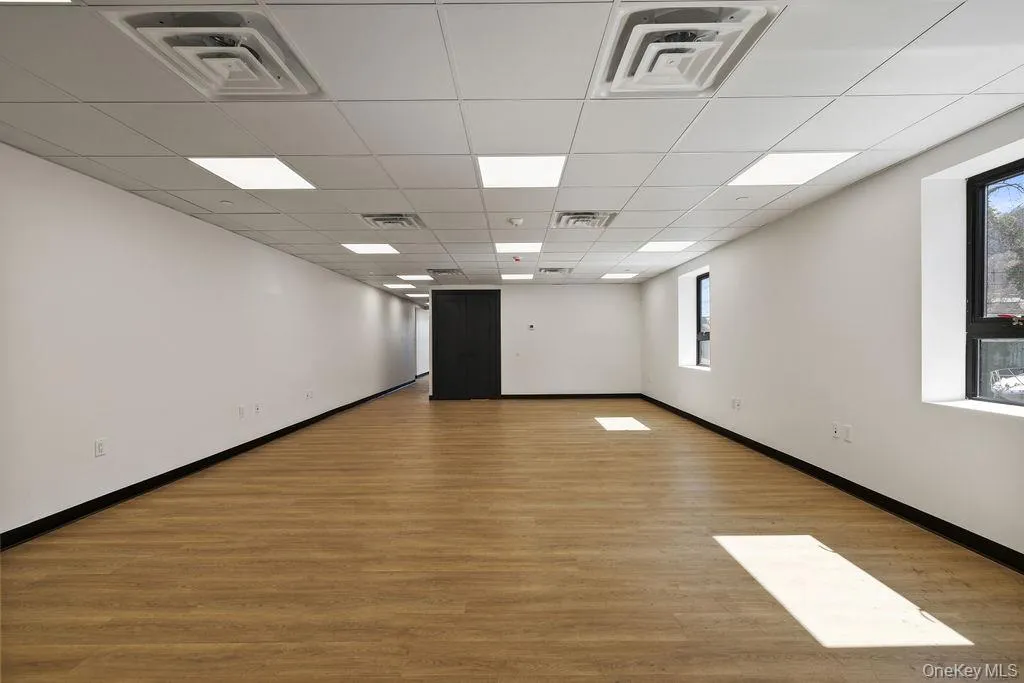 Spare room with light wood finished floors and a paneled ceiling Spare room with light wood finished floors and a paneled ceiling