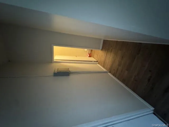 Corridor with dark wood-type flooring and a high ceiling Corridor with dark wood-type flooring and a high ceiling