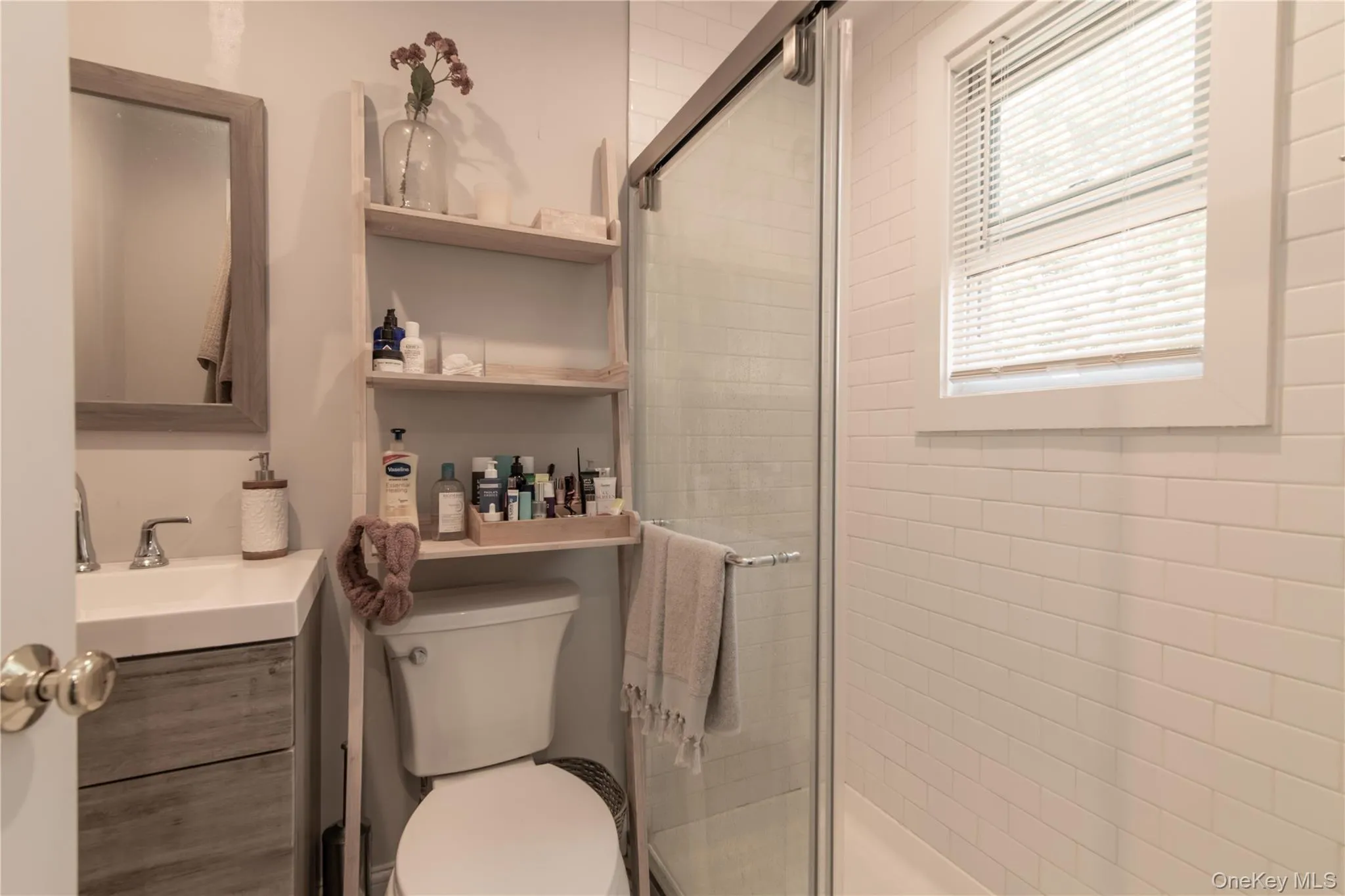 Bathroom featuring a shower stall and vanity Bathroom featuring a shower stall and vanity