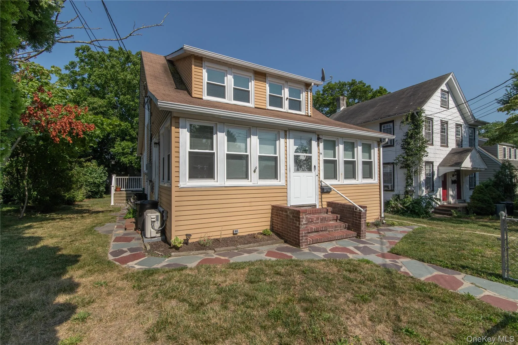 Bungalow-style house with a front yard, entry steps, and roof with shingles Bungalow-style house with a front yard, entry steps, and roof with shingles
