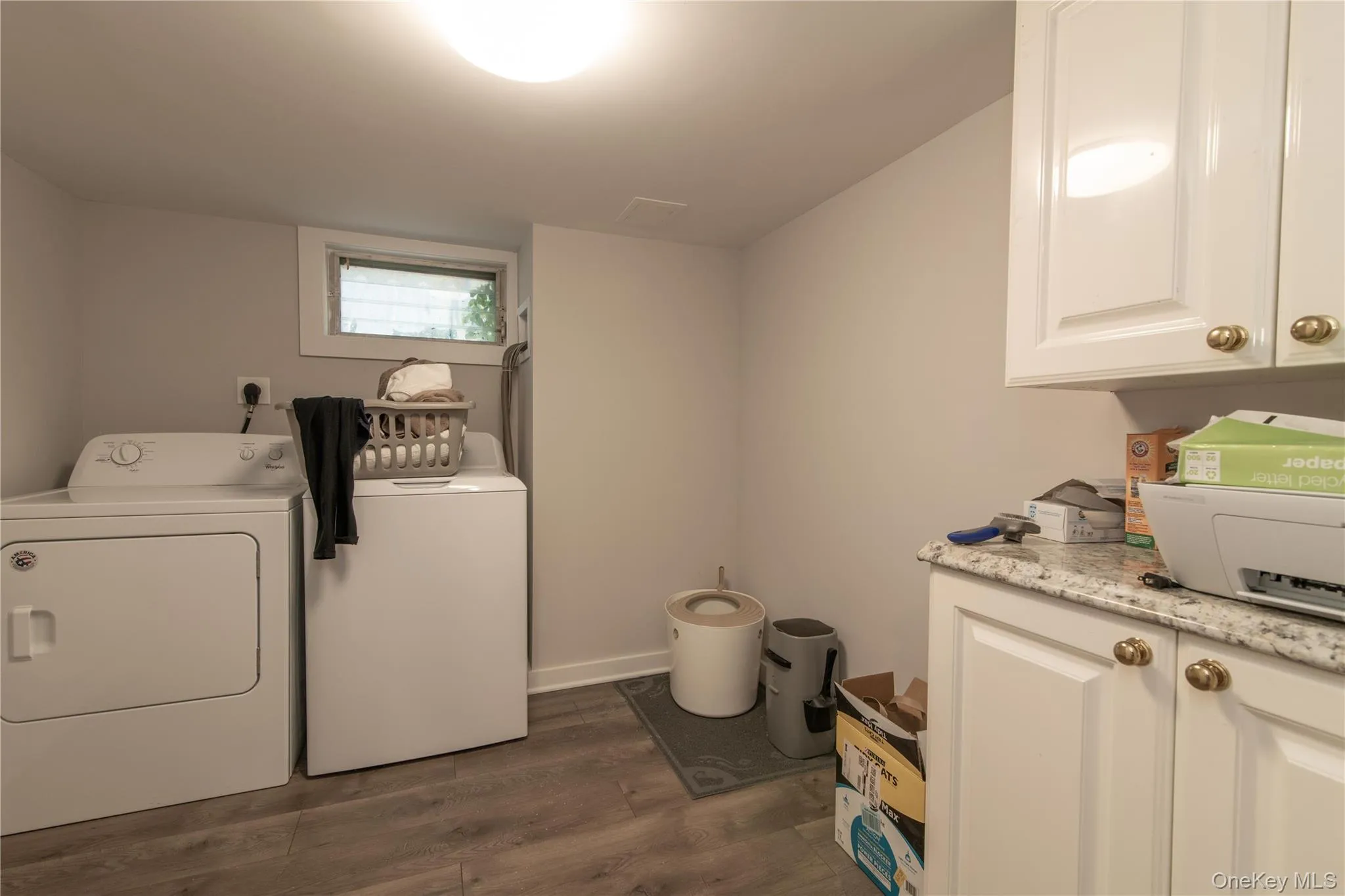 Washroom featuring dark wood-style floors and washer and dryer Washroom featuring dark wood-style floors and washer and dryer