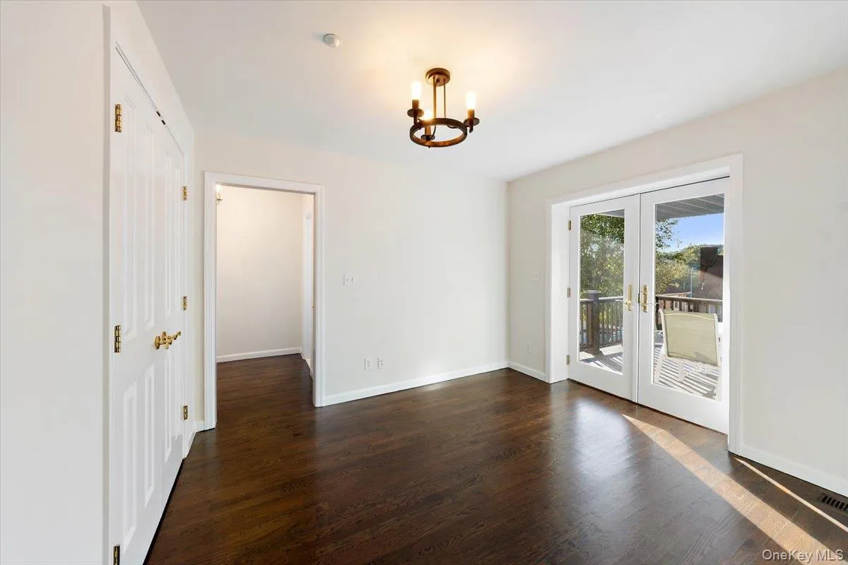 Den or office with dark wood-type flooring, french door, and a chandelier Den or office with dark wood-type flooring, french door, and a chandelier