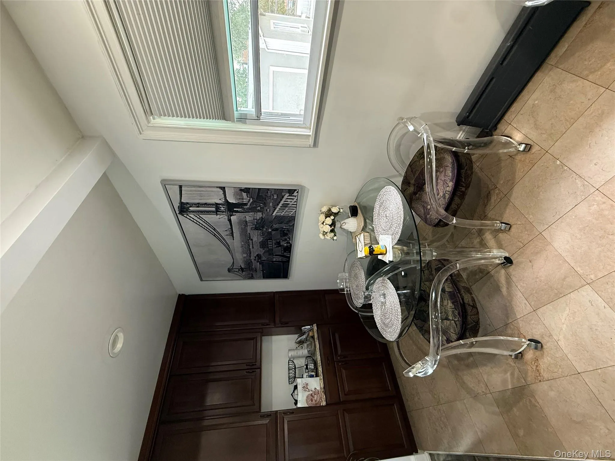 Dining space featuring baseboard heating and light tile patterned floors Dining space featuring baseboard heating and light tile patterned floors