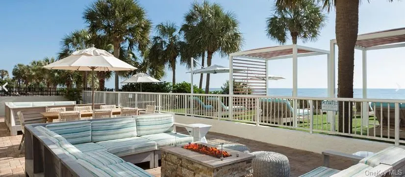 View of patio with an outdoor living space with a fire pit and a water view View of patio with an outdoor living space with a fire pit and a water view
