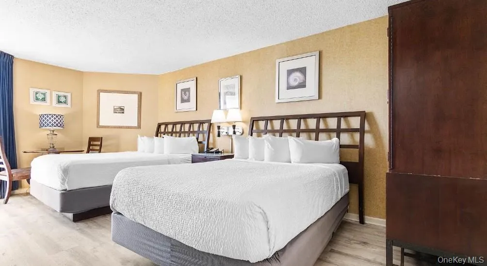 Bedroom with a textured ceiling and light wood-type flooring Bedroom with a textured ceiling and light wood-type flooring