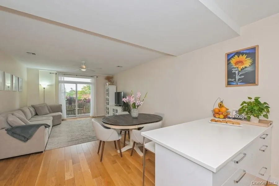 Dining room with light wood-type flooring and a ceiling fan Dining room with light wood-type flooring and a ceiling fan