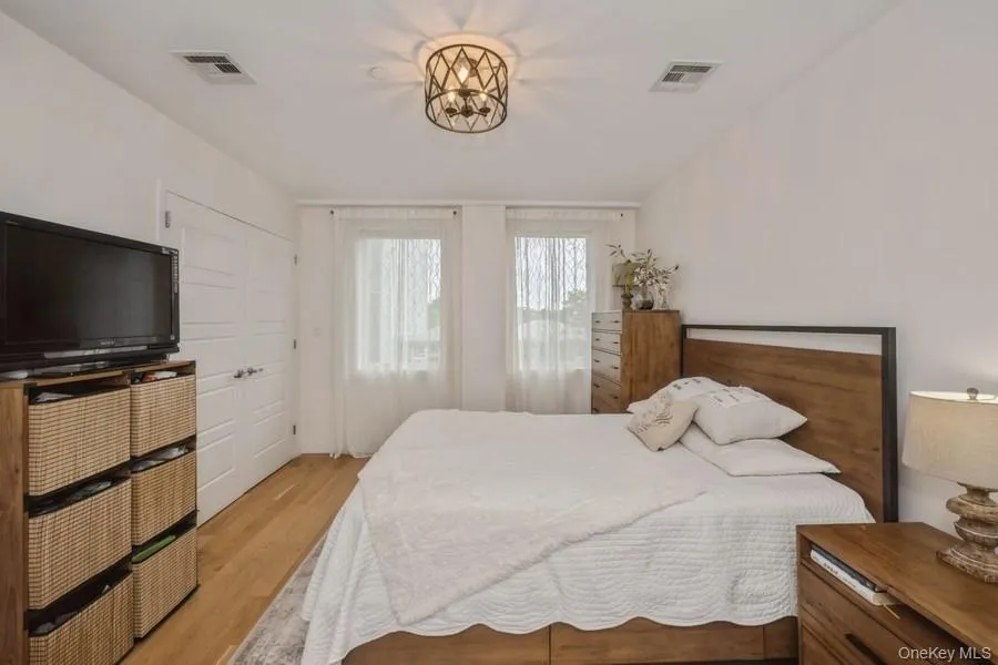 Bedroom featuring light wood-style floors and a closet Bedroom featuring light wood-style floors and a closet