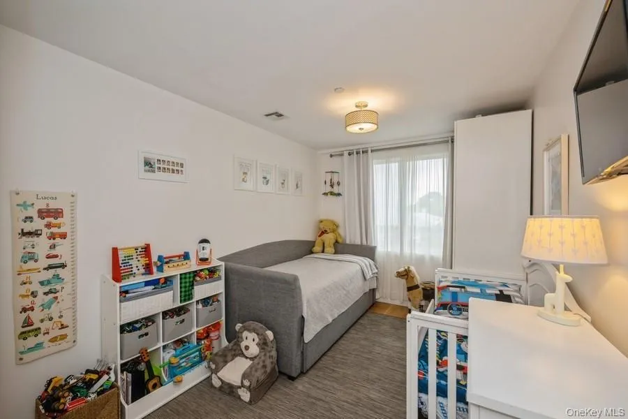 Bedroom featuring dark wood-style flooring Bedroom featuring dark wood-style flooring