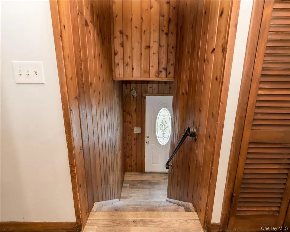 Foyer entrance with wood finished floors and wooden walls Foyer entrance with wood finished floors and wooden walls
