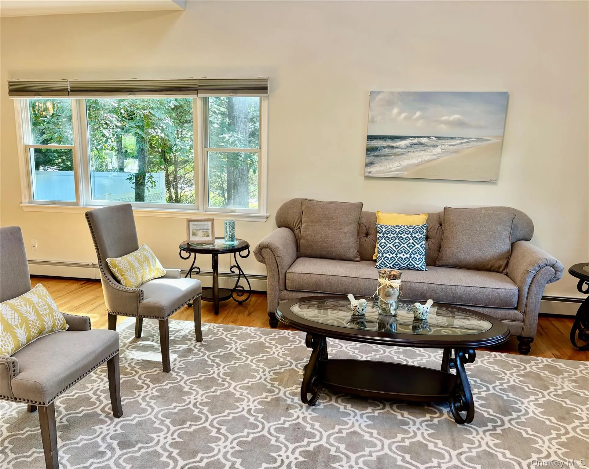 Living room with wood finished floors and a baseboard heating unit Living room with wood finished floors and a baseboard heating unit