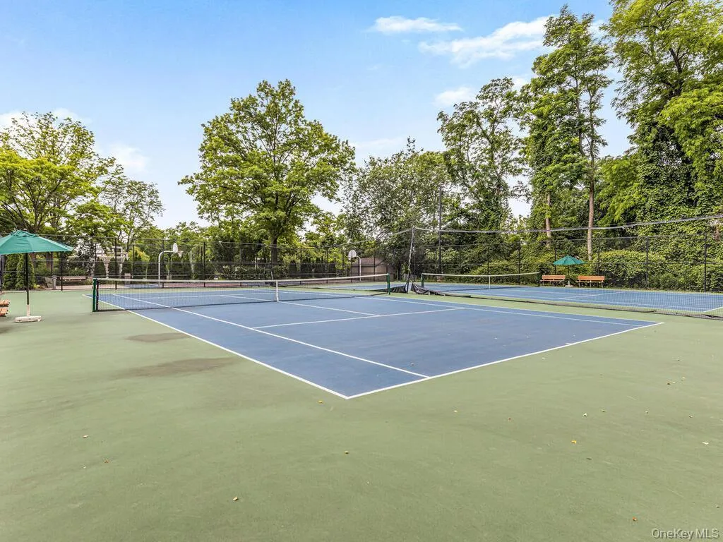View of tennis court featuring community basketball court View of tennis court featuring community basketball court
