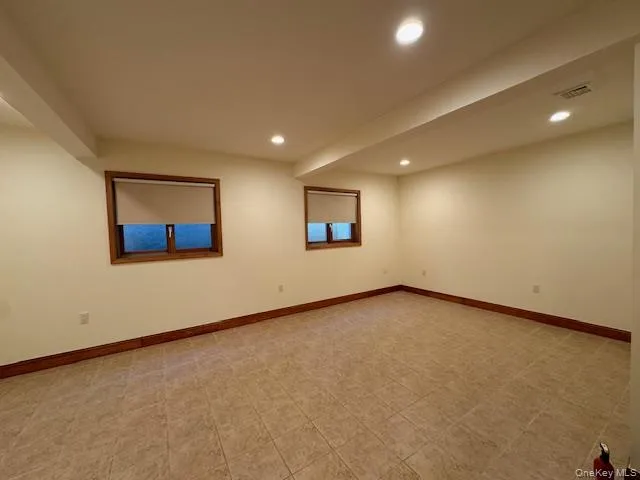 Unfurnished room with recessed lighting and beam ceiling Unfurnished room with recessed lighting and beam ceiling