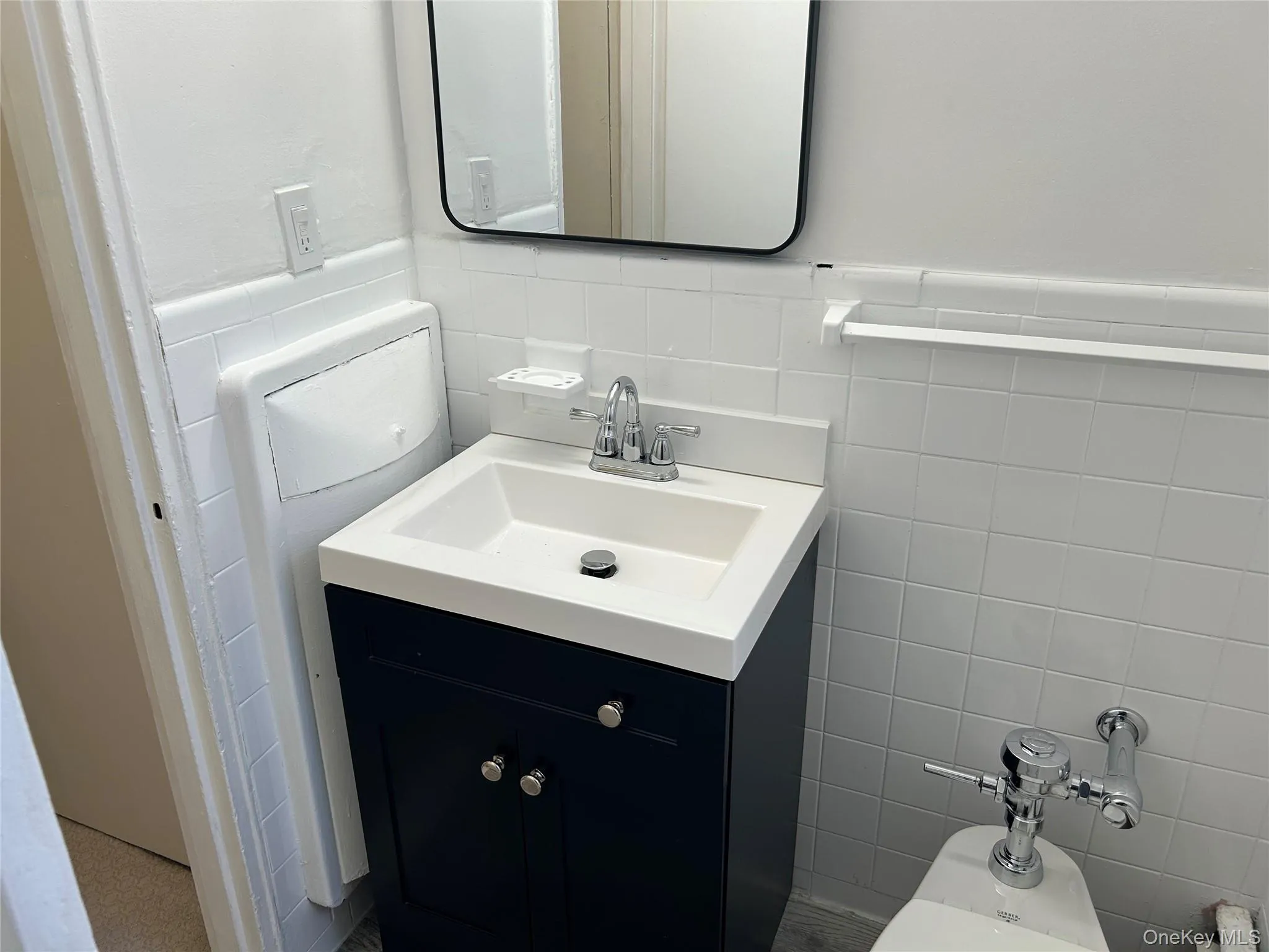Bathroom featuring tile walls and vanity Bathroom featuring tile walls and vanity