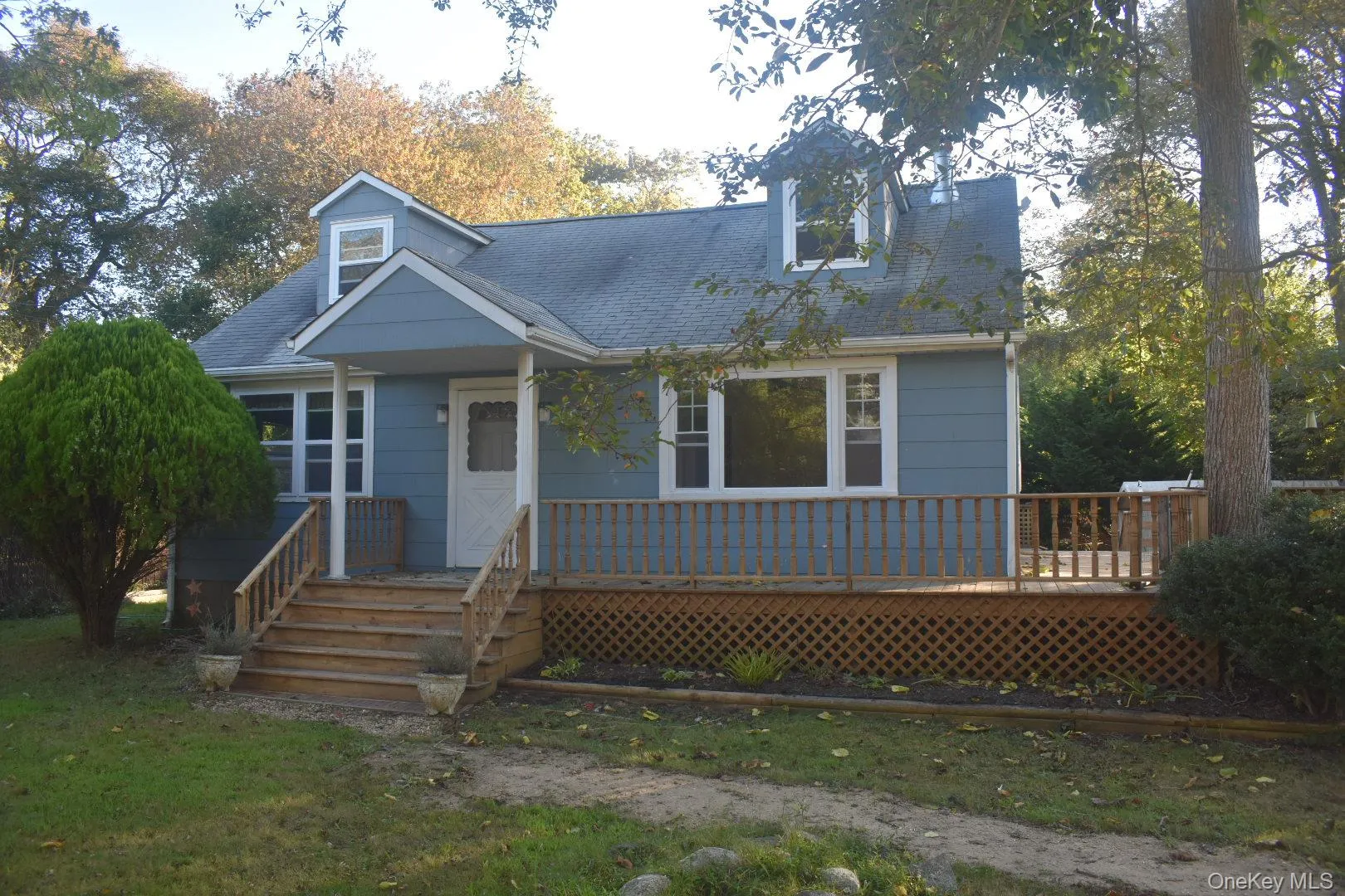 Cape cod home featuring a shingled roof Cape cod home featuring a shingled roof