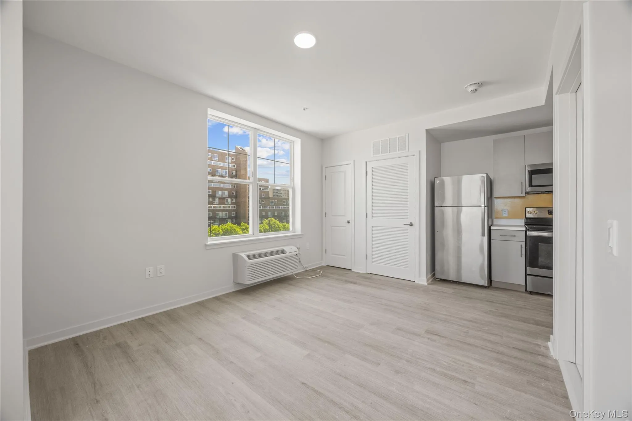 Unfurnished dining area with light wood-style floors and baseboards Unfurnished dining area with light wood-style floors and baseboards