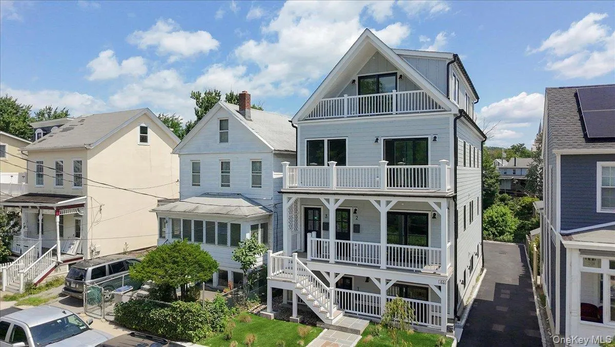 View of front of home featuring a balcony, stairs, and covered porch View of front of home featuring a balcony, stairs, and covered porch
