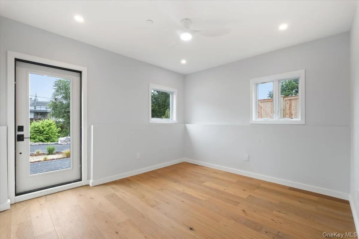 Spare room featuring healthy amount of natural light, light wood-style floors, ceiling fan, and recessed lighting Spare room featuring healthy amount of natural light, light wood-style floors, ceiling fan, and recessed lighting