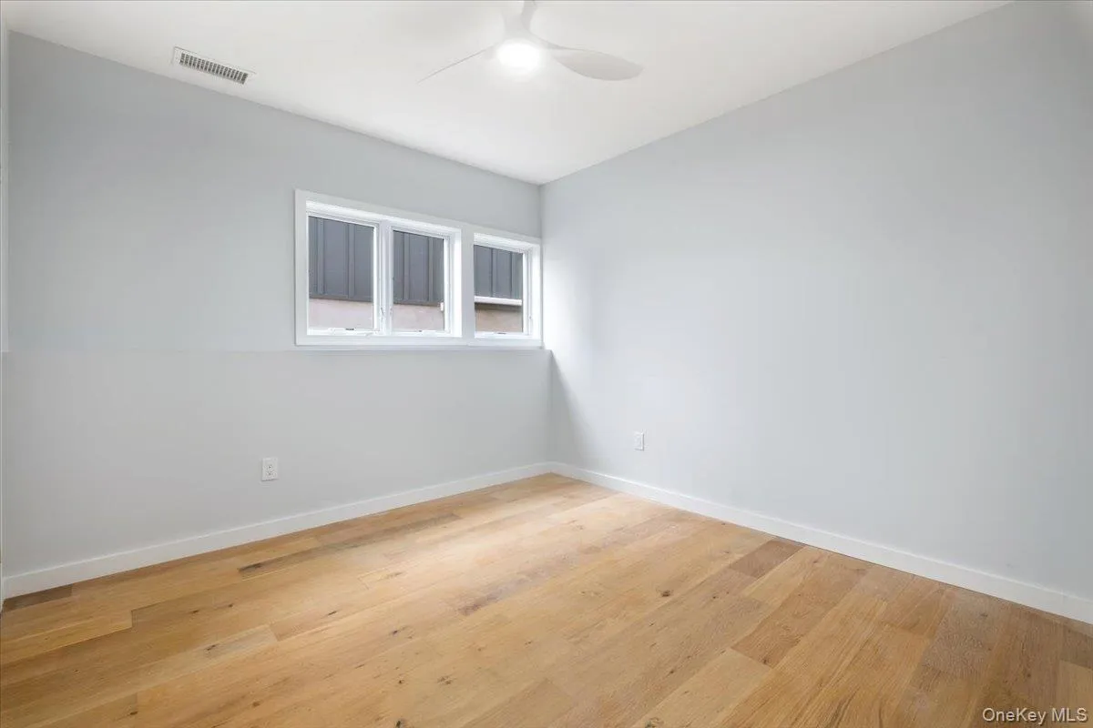 Spare room with a ceiling fan and light wood-style floors Spare room with a ceiling fan and light wood-style floors