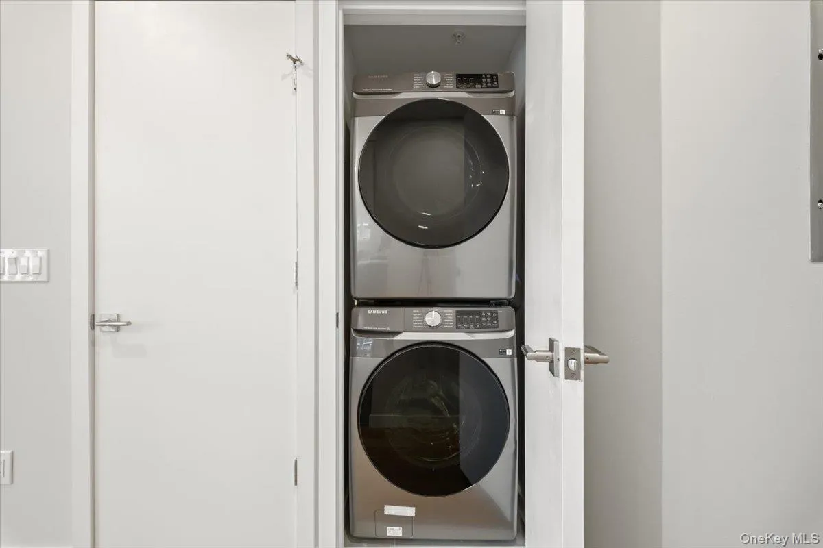Laundry room featuring estacked washer and dryer Laundry room featuring estacked washer and dryer
