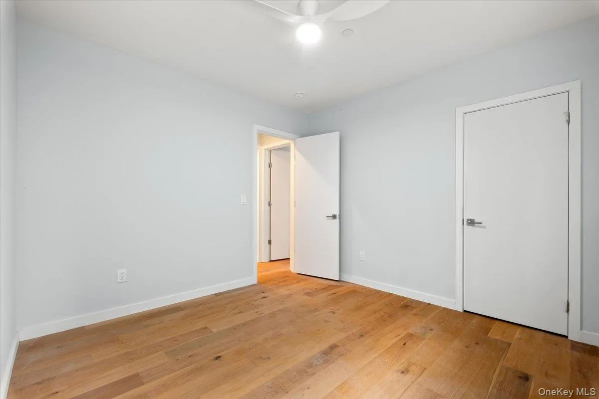 Unfurnished bedroom with light wood-style floors and a ceiling fan Unfurnished bedroom with light wood-style floors and a ceiling fan