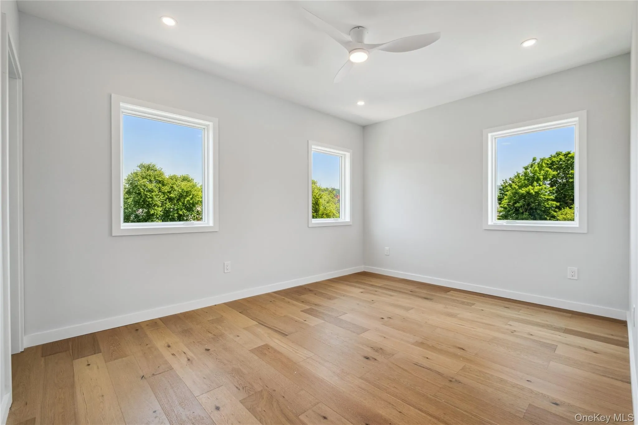 Unfurnished room featuring ceiling fan, light wood-style floors, and recessed lighting Unfurnished room featuring ceiling fan, light wood-style floors, and recessed lighting