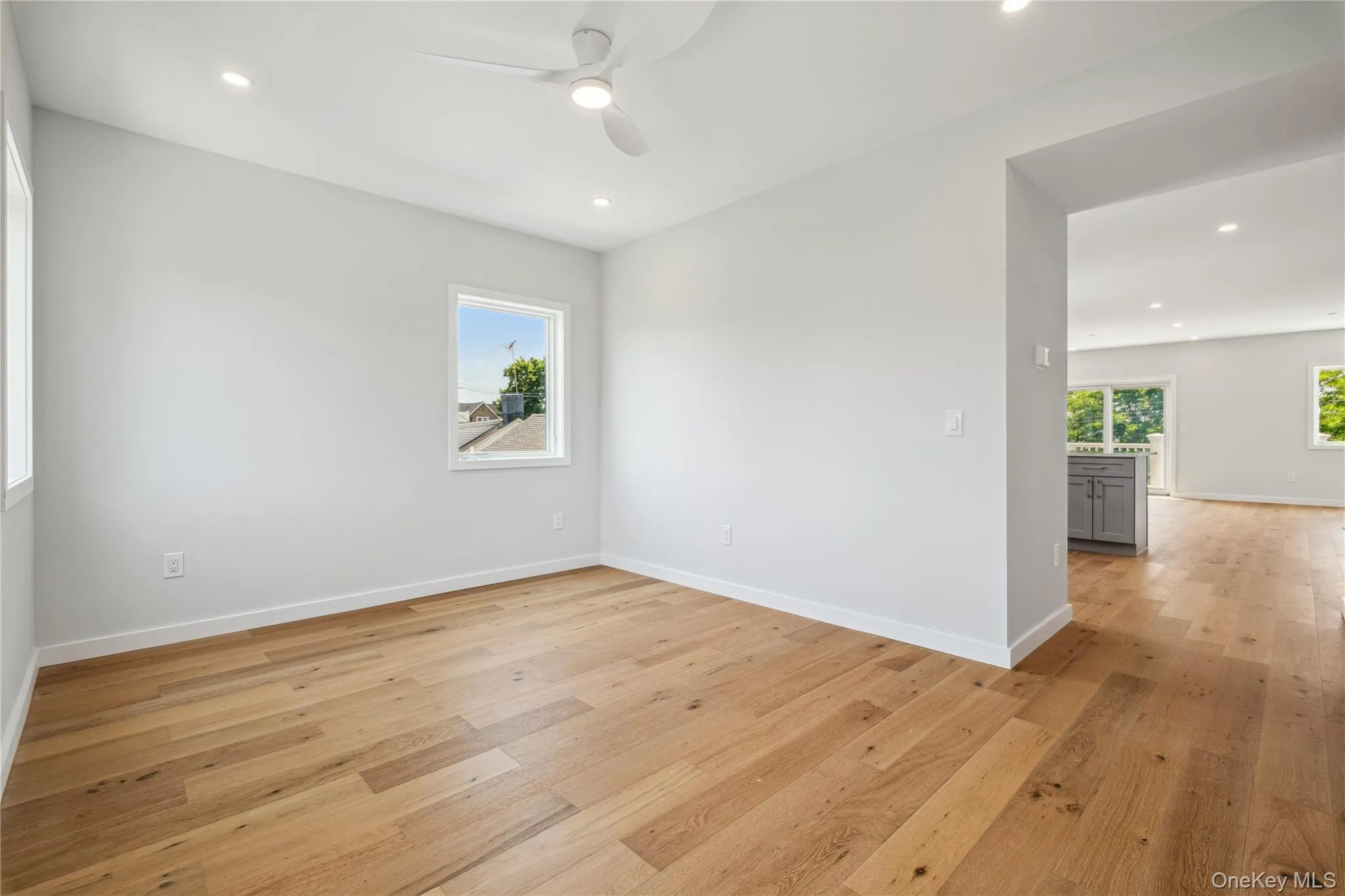 Empty room featuring ceiling fan, light wood-style floors, and recessed lighting Empty room featuring ceiling fan, light wood-style floors, and recessed lighting