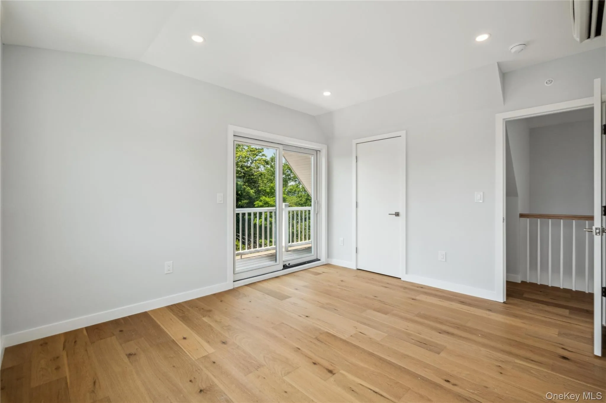 Unfurnished bedroom featuring access to exterior, light wood-style flooring, recessed lighting, and vaulted ceiling Unfurnished bedroom featuring access to exterior, light wood-style flooring, recessed lighting, and vaulted ceiling