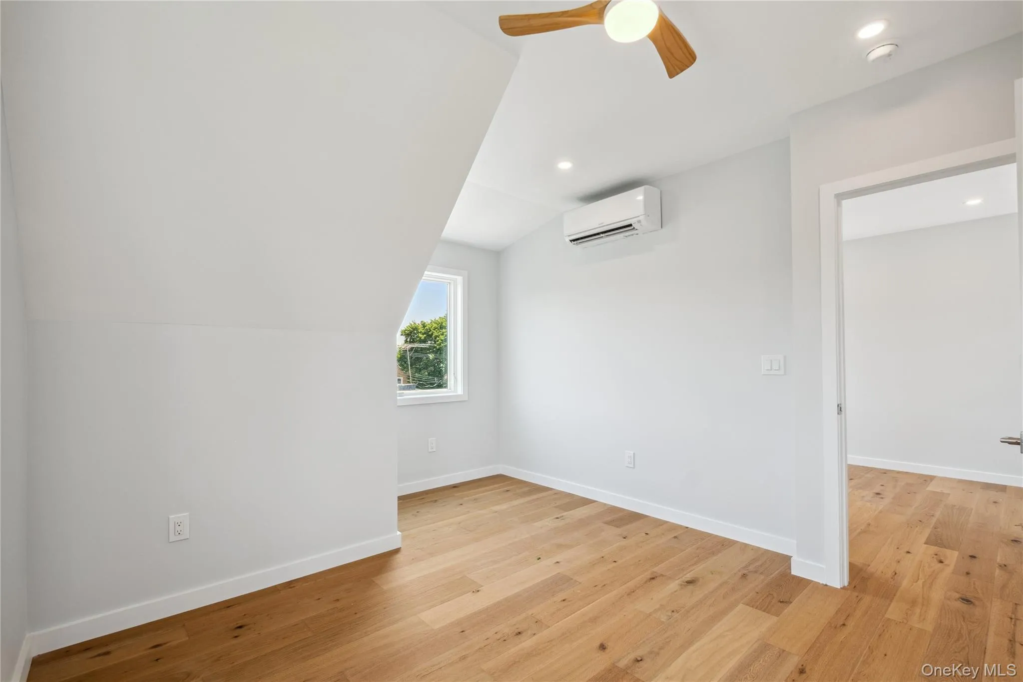 Bonus room with an AC wall unit, a ceiling fan, light wood-type flooring, recessed lighting, and lofted ceiling Bonus room with an AC wall unit, a ceiling fan, light wood-type flooring, recessed lighting, and lofted ceiling