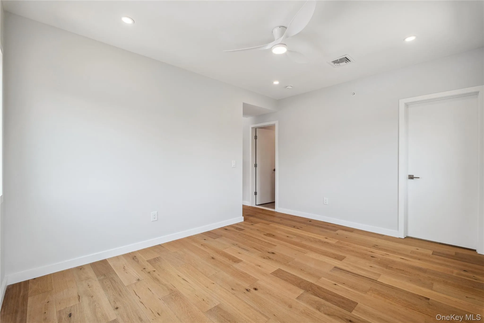 Unfurnished room with ceiling fan, light wood-type flooring, and recessed lighting Unfurnished room with ceiling fan, light wood-type flooring, and recessed lighting