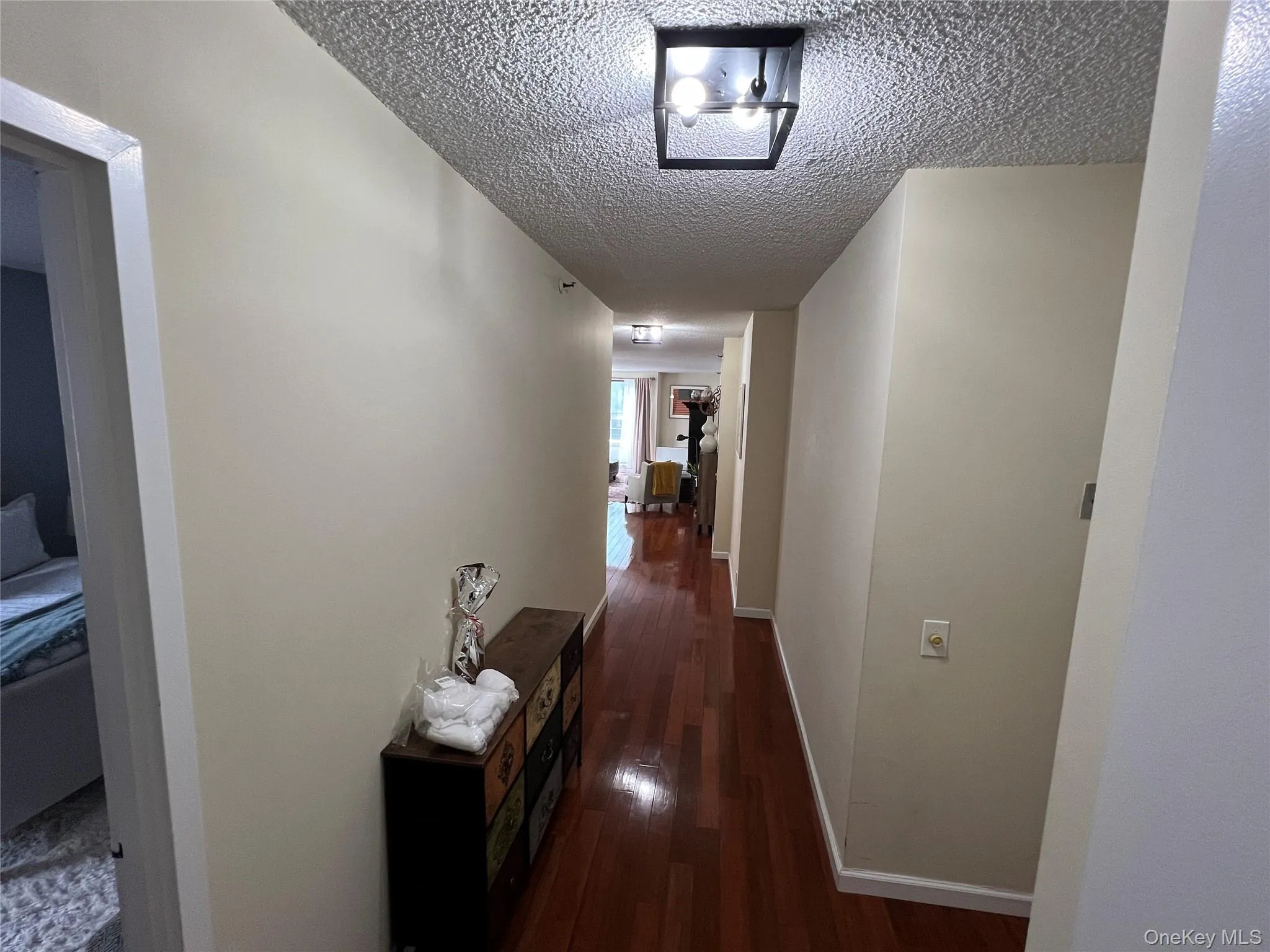 Hall with dark wood-type flooring, and baseboards Hall with dark wood-type flooring, and baseboards