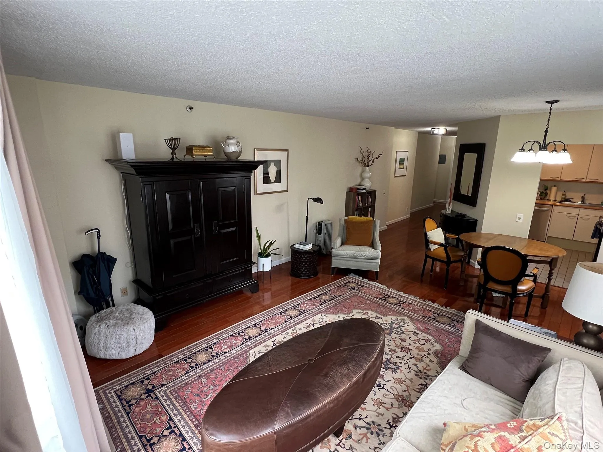 Living area with a textured ceiling and wood finished floors Living area with a textured ceiling and wood finished floors